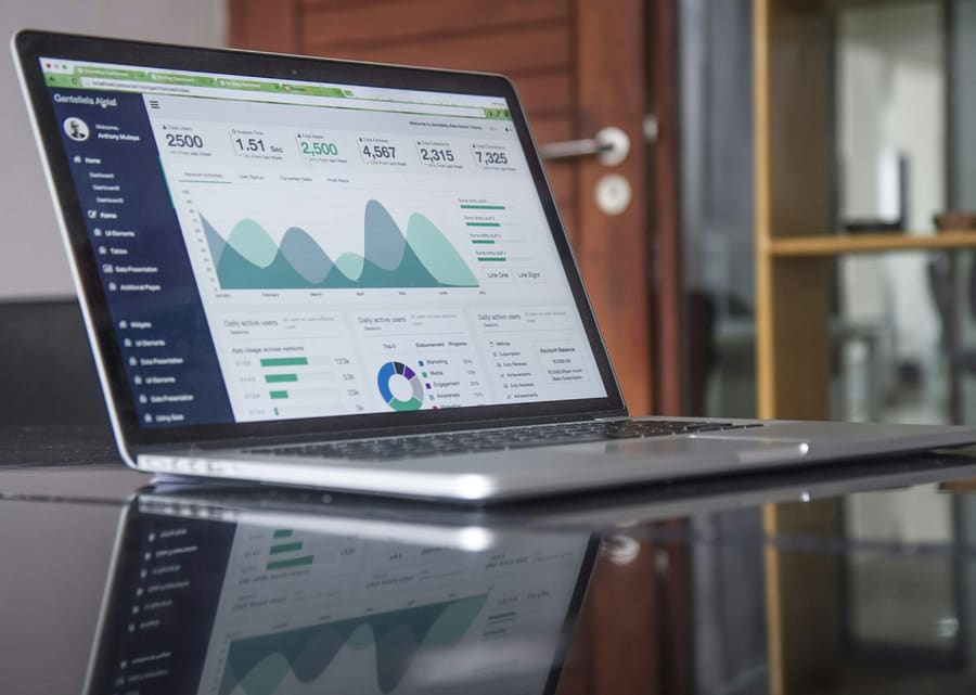 Professional workspace with laptop showing business charts
